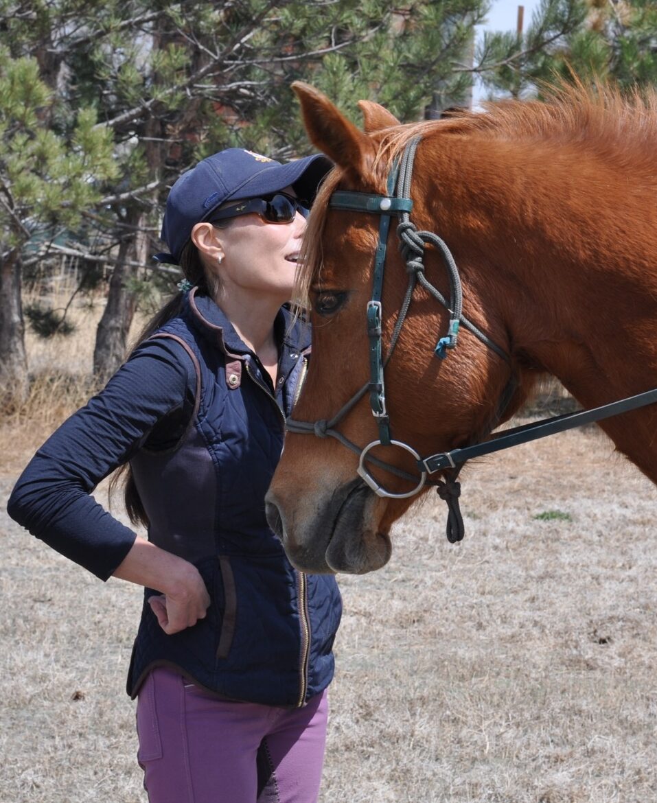 Adaptive EQ Founder, Euki Binns, working with a client's desert bred Arabian competing in endurance racing.
